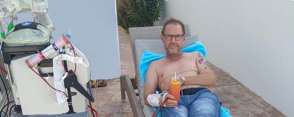 man ligger på altan och får dialys 